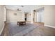 Open living room with wood-look tile floors and views to kitchen and hallways at 2158 Stillwood Way, St Cloud, FL 34771