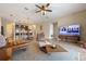 Spacious living room with hardwood floors, a large TV, and open kitchen views at 2158 Stillwood Way, St Cloud, FL 34771