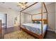 Main bedroom with a canopy bed and en-suite bathroom at 2158 Stillwood Way, St Cloud, FL 34771