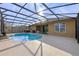 Inviting screened pool with waterfall feature and spacious deck at 2158 Stillwood Way, St Cloud, FL 34771