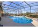 Inviting pool area with covered patio and waterfall feature at 2158 Stillwood Way, St Cloud, FL 34771