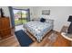 King-size bed, wood floors, and sliding door access to balcony at 230 La Casa # 230, Lake Wales, FL 33898