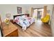 Bedroom with king bed, yellow chair, and balcony access at 230 La Casa # 230, Lake Wales, FL 33898