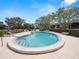 Kidney shaped swimming pool with lounge chairs and landscaping at 230 La Casa # 230, Lake Wales, FL 33898