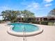 Kidney shaped community pool with plenty of lounge chairs at 230 La Casa # 230, Lake Wales, FL 33898