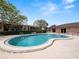 Kidney shaped swimming pool with surrounding patio and lounge chairs at 230 La Casa # 230, Lake Wales, FL 33898