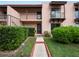 Front view of condo building with walkway and landscaping at 230 La Casa # 230, Lake Wales, FL 33898
