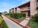 Side view of condo building showcasing landscaping and walkway at 230 La Casa # 230, Lake Wales, FL 33898