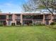 Tan colored two-story condo building with balconies and lush green lawn at 230 La Casa # 230, Lake Wales, FL 33898