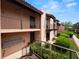 Condo building exterior with walkway and lush green landscaping at 230 La Casa # 230, Lake Wales, FL 33898