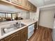 Kitchen with wood cabinets, white appliances and a pass-through at 230 La Casa # 230, Lake Wales, FL 33898