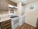 Kitchen features white appliances and wood cabinets at 230 La Casa # 230, Lake Wales, FL 33898