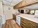 Efficient kitchen with white appliances and wood cabinets at 230 La Casa # 230, Lake Wales, FL 33898
