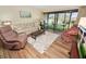 Living room with sliding doors to a balcony and view of the courtyard at 230 La Casa # 230, Lake Wales, FL 33898