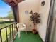 Peaceful screened balcony with chair and view of green space at 230 La Casa # 230, Lake Wales, FL 33898