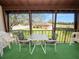 Screened balcony with table and chairs, overlooking a courtyard at 230 La Casa # 230, Lake Wales, FL 33898