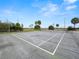 Outdoor tennis court with green surface and trees in background at 230 La Casa # 230, Lake Wales, FL 33898