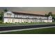 Row of townhouses with farmhouse-style architecture and landscaping at 2347 Southbury Dr, Kissimmee, FL 34744