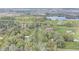 Aerial view of the property with a large lake and lush green trees at 2432 4Th St, Orlando, FL 32820