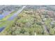 Expansive aerial view of a community with lush greenery, ponds, and waterways at 2432 4Th St, Orlando, FL 32820