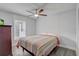 Cozy bedroom with a queen bed, ceiling fan, and a window providing natural light at 2432 4Th St, Orlando, FL 32820