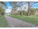 Spacious front yard with a long driveway and green grass leading to the inviting home at 2432 4Th St, Orlando, FL 32820