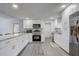 Modern kitchen featuring stainless steel appliances, ample counter space, and sleek white cabinetry at 2432 4Th St, Orlando, FL 32820
