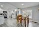 Well-lit dining area adjacent to a modern kitchen, featuring white cabinets and stainless steel appliances at 2432 4Th St, Orlando, FL 32820