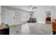 Bright living room with modern flooring, a ceiling fan, and a glimpse into the dining area at 2432 4Th St, Orlando, FL 32820