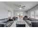 Open living room has a ceiling fan and access to the kitchen and dining area at 2432 4Th St, Orlando, FL 32820
