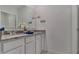 Double vanity bathroom with granite countertop and modern fixtures at 33459 Copper Hill Way, Sorrento, FL 32776