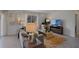 Living room boasts a cozy atmosphere with a gray sofa and large TV at 4261 Singing Mockingbird Blvd, Bartow, FL 33830