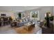 Bright living room with comfy sofa, large windows, and stylish coffee table at 4261 Singing Mockingbird Blvd, Bartow, FL 33830