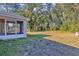 Spacious backyard with screened porch and mature trees at 43 Water Track Dr, Ocala, FL 34472