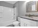 Clean bathroom featuring granite countertop, white vanity, and shower/tub combo at 43 Water Track Dr, Ocala, FL 34472