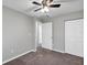 Bedroom with carpet, ceiling fan, double door closet and window at 43 Water Track Dr, Ocala, FL 34472