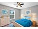 Bright bedroom with bed, blue accents, and natural light from large window at 43 Water Track Dr, Ocala, FL 34472