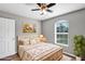 Staged bedroom featuring a bed, window with blinds, and natural light at 43 Water Track Dr, Ocala, FL 34472