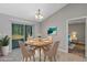 Cozy dining area with a round table, chandelier, and sliding glass doors leading to the outdoor space at 43 Water Track Dr, Ocala, FL 34472
