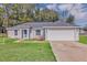 Charming single-story home with a two-car garage and well-maintained lawn in a serene neighborhood at 43 Water Track Dr, Ocala, FL 34472