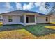 Rear view of house showing screened porch and yard at 43 Water Track Dr, Ocala, FL 34472