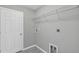 Laundry room with built-in shelving and tile flooring at 43 Water Track Dr, Ocala, FL 34472