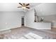 Living room with grey walls, carpeted floors, and kitchen view at 43 Water Track Dr, Ocala, FL 34472