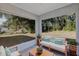 Relaxing screened patio with comfortable seating and view of the spacious, tree-filled backyard at 43 Water Track Dr, Ocala, FL 34472