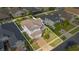 Aerial view of the house showing its location in a well-maintained community with lush landscaping and green lawns at 4455 Indigo Sky Ln, Kissimmee, FL 34744