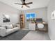 Cozy bedroom with a ceiling fan, area rug, a workstation, and ample natural light at 4455 Indigo Sky Ln, Kissimmee, FL 34744