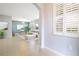 Bright living room featuring tile flooring, and large windows with plantation shutters and freshly painted walls at 4455 Indigo Sky Ln, Kissimmee, FL 34744