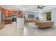 Open-concept living room and kitchen with stainless steel appliances, and lots of seating for entertaining guests at 4455 Indigo Sky Ln, Kissimmee, FL 34744