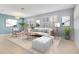 Bright living room with tile floors, neutral decor, area rug, and large windows with plantation shutters at 4455 Indigo Sky Ln, Kissimmee, FL 34744