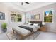 Serene main bedroom with a tray ceiling, natural light and a seating bench, creating a relaxing retreat at 4455 Indigo Sky Ln, Kissimmee, FL 34744